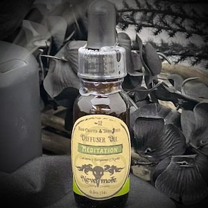 May include: A small, dark glass bottle of diffuser oil with a black dropper. The label reads "Meditation" and "Nevermore". The bottle is filled with a brown liquid and is 0.5 fl oz (14 ml).