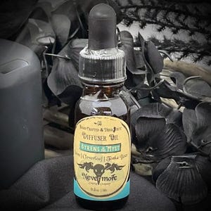 May include: A dark glass bottle with a black dropper, labeled "Diffuser Oil BYRENS MYST." The label is cream-colored with teal accents and features the text "Nevermore." The bottle contains 0.5 fl oz (14 ml) of oil.