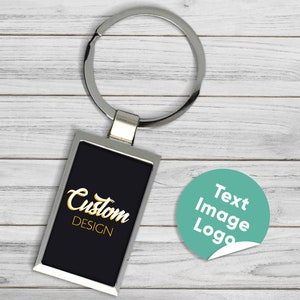 May include: A silver keychain with a black rectangular tag that says "Custom DESIGN" in gold lettering. A round, teal sticker with the text "Text Image Logo" is also shown.