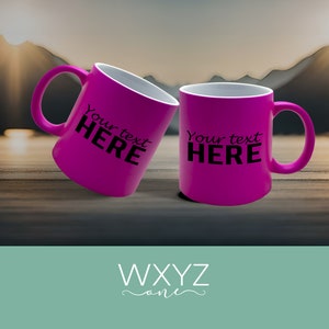 May include: Two pink ceramic mugs with white interiors. The mugs have black text that reads "Your text HERE".