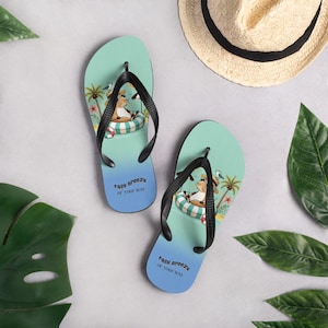 May include: A pair of flip-flops with a light blue and turquoise gradient design. Each flip-flop features a cartoon cow relaxing in a pool float, palm trees, and the text "easy breezy or your text". Black straps complete the design.