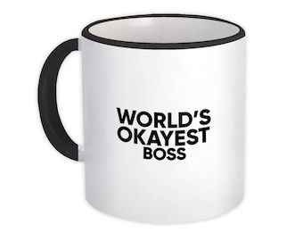 May include: White ceramic mug with a black rim and handle. The mug has the text "WORLD'S OKAYEST BOSS" printed in black.