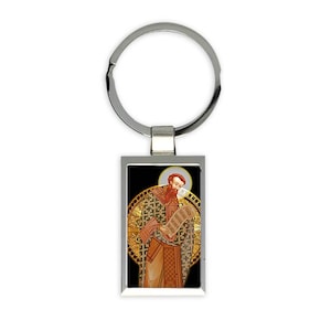 May include: Silver keychain with a rectangular image of a religious figure holding a scroll. The image is set against a black background with a gold halo and ornate design.