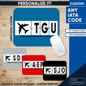 May include: A blue rectangular mousepad with the text "TGU" and a silhouette of an airplane, representing Toncontin International Airport. Additional mousepads in gray, red, and black with different airport codes are also shown. The text "PERSONALIZE IT!" is visible.