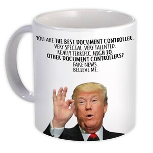 May include: White ceramic mug with a handle featuring text that reads "YOU ARE THE BEST DOCUMENT CONTROLLER." The mug also has an image of a man making an "okay" hand gesture.