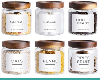 May include: Six glass jars with wooden lids, each labeled with pantry staples like cereal, sugar, coffee beans, oats, penne, and dried fruit. The labels are white with black text. The text at the bottom says "MINIMALIST PANTRY LABELS FOR KITCHEN ORGANIZATION."