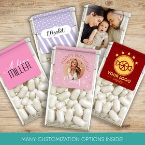 May include: Five clear plastic containers filled with white mints. Each container has a different personalized label. One label has a purple polka dot background with the name "Elizabeth" in black text. Another label has a pink background with the name "Alice Miller" in black text. A third label has a pink background with a photo of a woman blowing confetti and the text "Happy Birthday Carol". A fourth label has a red background with a gold star and the text "Your Logo Here". The fifth label has a photo of a family of three.
