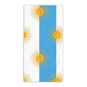 May include: A white and light blue beach towel with a repeating pattern of yellow suns. The suns have a stylized face in the center.