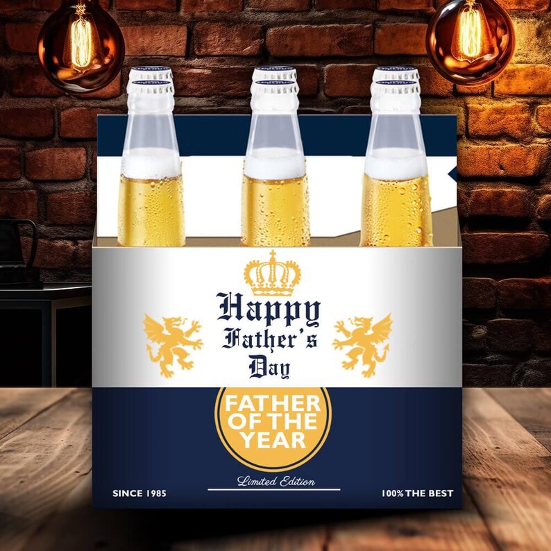 May include: A Father's Day gift set featuring three beer bottles. The packaging includes the text "Happy Father's Day" and "Father of the Year". The design incorporates a crown and gold accents, with the text "Since 1985" and "100% The Best".