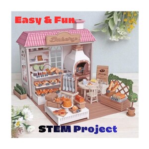 Peut inclure: Un ensemble de boulangerie miniature avec un toit rose, un four en brique et des étagères remplies de pains et de pâtisseries. Le kit comprend une table, des chaises et un petit panneau. Le texte "EASY & FUN" et "STEM Project" est visible.