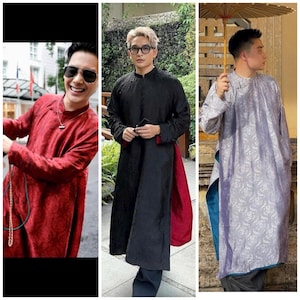 May include: Three men wearing traditional Vietnamese long tunics, or áo dài. The tunics are in different colors and patterns: red, black with a red trim, and a light blue with a white floral pattern.