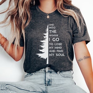 Cute unisex pine tree design with half a tree on the left and text on the right. Text reads 'and into the woods I go to lose my mind and find my soul'.