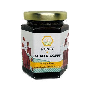 May include: A glass jar with a gold lid filled with dark brown honey. The label reads "HONEY + CACAO & COFFEE Honey + Farm Made by Texas Bees | Net Wt 8 oz (227g)"