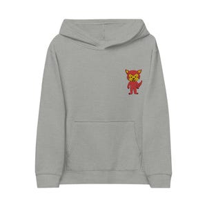 Peut inclure: Un sweat à capuche gris chiné avec une poche kangourou et une capuche. Le sweat à capuche présente un petit renard de dessin animé brodé en rouge et jaune sur la poitrine gauche. Le renard est debout et tient un objet rouge.
