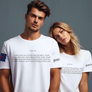 May include: Two white t-shirts with the Bible verse John 3:16 printed on them. The verse reads: "For God so loved the world, that he gave his only begotten Son, that whosoever believeth in him should not perish, but have everlasting life."