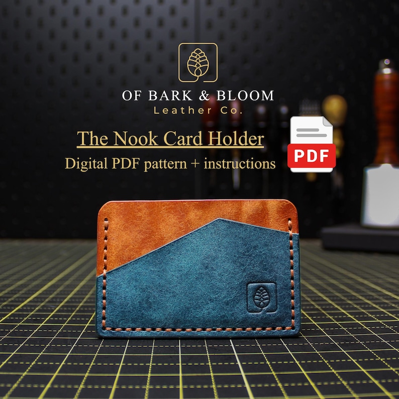 May include: A handmade leather card holder with a two-tone design. The top section is brown, and the bottom is teal, with a stitched border. The card holder has the text "The Nook Card Holder" and "Digital PDF pattern + instructions".