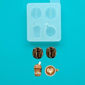 May include: A clear silicone mold with four cavities, including two coffee beans, a to-go coffee cup, and a coffee cup with a heart design. Below are two brown coffee beans, a brown to-go coffee cup with "Coffee" text, and a brown coffee cup with a heart.