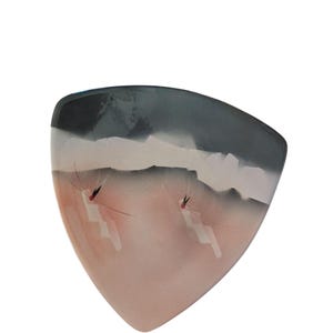 May include: A triangular ceramic dish with a painted landscape design. The top section is dark grey, fading to white and then a soft pink. Two insect-like figures with red accents are painted on the pink area.