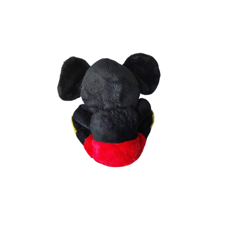 May include: A plush toy of a popular cartoon mouse, viewed from the back. The toy is mainly black with large, rounded ears. It has a red bottom and yellow accents on the sides. The toy is sitting down.