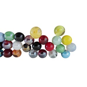 May include: A collection of colorful glass marbles in various sizes and colors. The marbles include shades of red, green, yellow, blue, black, and iridescent finishes. Some marbles have unique patterns and swirls.
