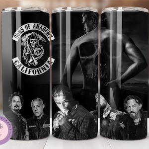 May include: A set of three black and white stainless steel tumblers featuring a Sons of Anarchy theme. The tumblers feature a skull, the Sons of Anarchy logo, and various characters from the show.