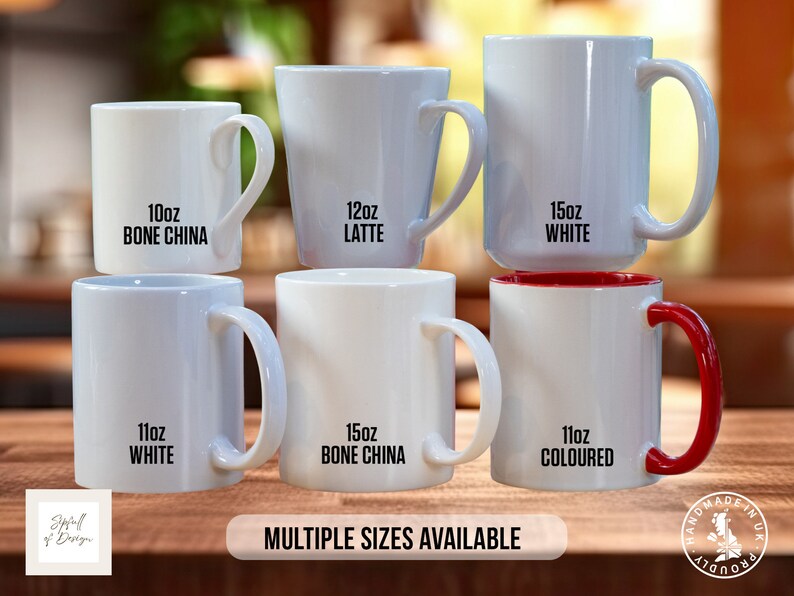 May include: Six white ceramic mugs with black text indicating size and material. The mugs are stacked in a pyramid shape on a wooden surface. The text on the mugs reads: 10oz Bone China, 12oz Latte, 15oz White, 11oz White, 15oz Bone China, 11oz Coloured. The text "MULTIPLE SIZES AVAILABLE" is printed below the mugs.