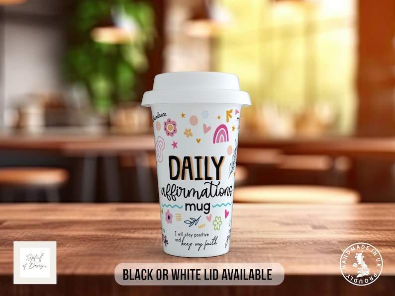 May include: White travel mug with a colorful design featuring flowers, stars, and rainbows. The mug says "Daily affirmations mug" and "I will stay positive and keep my faith". Black or white lid available.