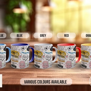 May include: Five mugs with different coloured rims, each featuring a white background with black and white doodles and the text "A cup of positivity tea. You are a ray of sunshine. Believe in yourself." The mugs are light blue, blue, grey, red, and orange.