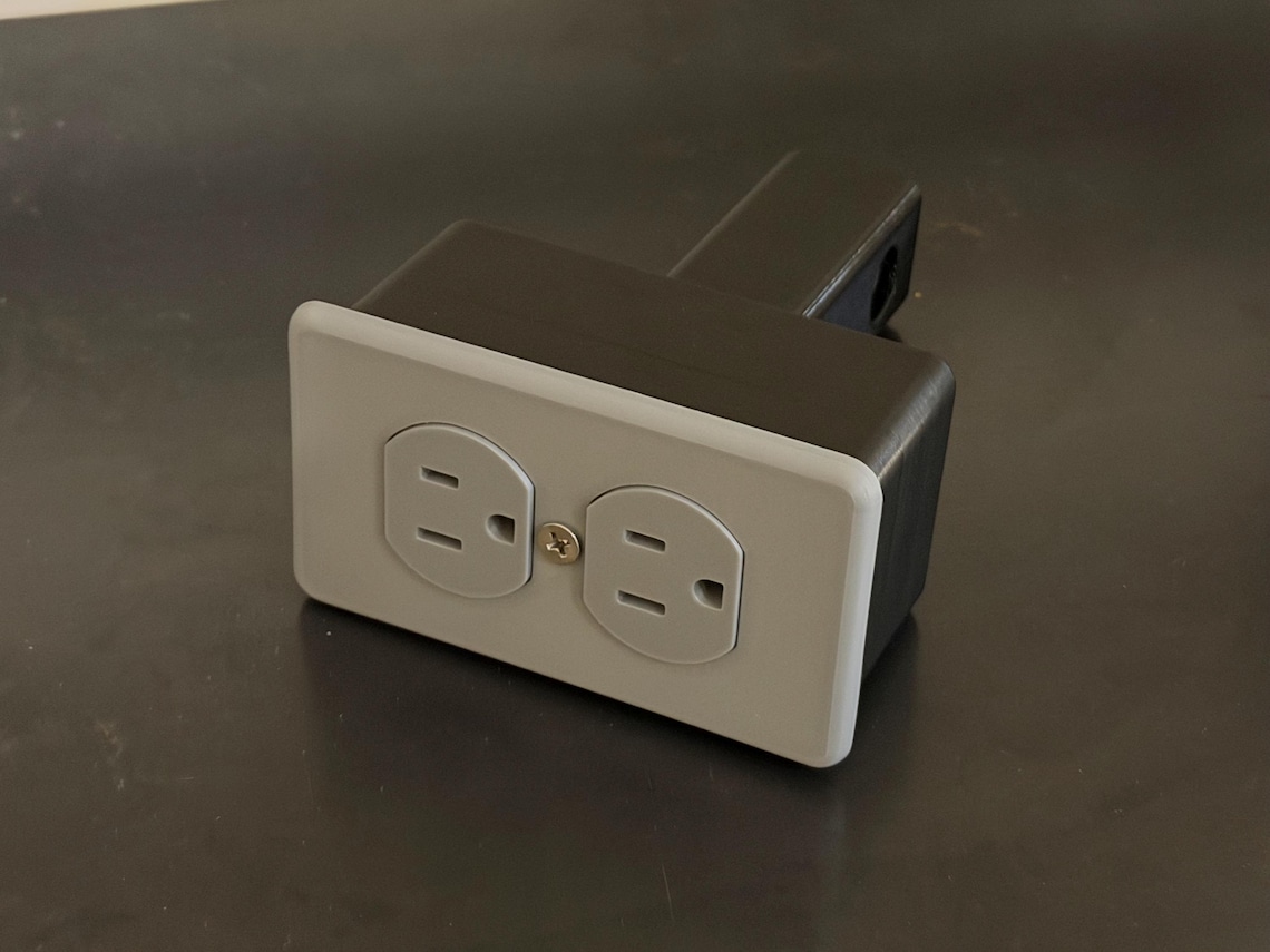 Fake electrical outlet tow hitch cover — mounted on vehicle