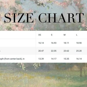 May include: A size chart with measurements in inches for XS, S, M, L, and XL. The chart includes width, length, and sleeve length measurements. The background features a soft, impressionistic floral and landscape design.