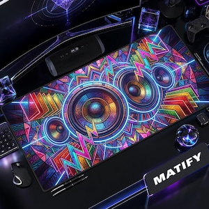 May include: A rectangular desk mat featuring a vibrant, multicolored geometric pattern with three prominent circular speaker designs. The artwork incorporates neon blue, pink, yellow, and green hues with sharp, angular lines and a stained-glass effect.