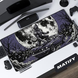 May include: A black and purple rectangular mousepad featuring a werewolf on a car with a full moon in the background. The design includes a house, trees, and shattered glass. The word "MATIFY" is printed on the bottom right corner.