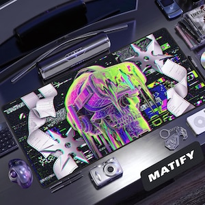 May include: A rectangular desk mat featuring a vibrant, glitch-art style graphic of a skull wearing headphones, surrounded by floating shuriken stars and scrolling paper strips against a dark, pixelated background with the word MATIFY.