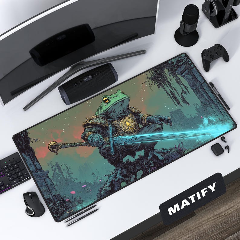 Epic fantasy art desk mat depicting a powerful frog knight in ornate armor, holding a glowing magical sword in a swampy, ruin-filled landscape. The detailed artwork is shown on a modern gaming desk setup.
