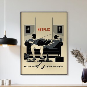 May include: A beige poster with a black frame featuring two men sitting on a sofa. The men are watching TV and one is holding a remote control. The poster has the text "NETFLIX" and "and fence" in black and red lettering.