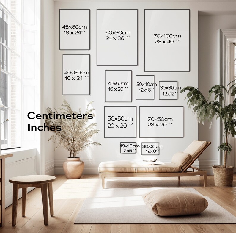 May include: A white wall with a variety of framed prints in different sizes. The prints are labeled with measurements in both centimeters and inches. The wall is decorated with a potted plant and a couch.