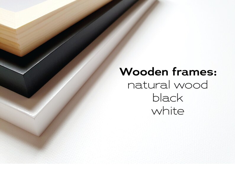 May include: Three wooden picture frames stacked on top of each other. The top frame is natural wood, the middle frame is black, and the bottom frame is white. Wooden frames: natural wood, black, white.