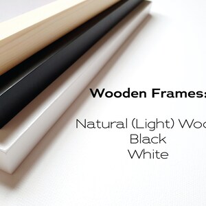 May include: Three wooden picture frames stacked on top of each other. The top frame is natural wood, the middle frame is black, and the bottom frame is white. The text "Wooden Frames:" is written above the frames, and the text "Natural (Light) Wood, Black, White" is written below the frames.