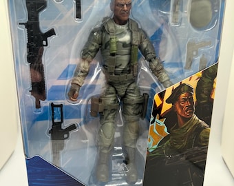 May include: A G.I. Joe Classified Series Sgt. Stalker action figure in a clear plastic package. The figure is dressed in a green and gray military uniform and comes with various accessories. The packaging includes a warning about small parts and is suitable for ages 4 and up.