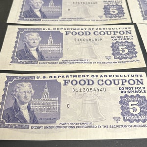 May include: Three vintage blue and white food coupons from the U.S. Department of Agriculture. Each coupon has a value of $5 and features a portrait of Thomas Jefferson, the Liberty Bell, and the text "Food Coupon".