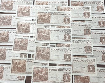 May include: A close-up of a pile of vintage US Department of Agriculture food coupons. Each coupon is white with black text and features a brown illustration of people sitting around a table. The text on the coupons reads "Food Coupon" and "Do Not Fold or Spindle".