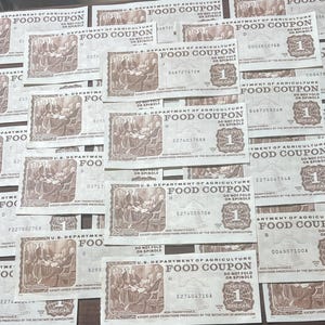 vintage paper food stamps/coupons from 1970’s 80’s. photo shows multiple examples of $1 denomination usda food coupons. each stamp is printed in tan ink with a scene of the signing of constitution. each note says “Food Coupon” and has large 1.