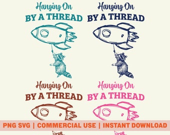 May include: Four variations of a digital design featuring a raccoon holding onto a rocket with the text "Hanging On By A Thread". The raccoon is in different colors: teal, blue, brown, and pink.