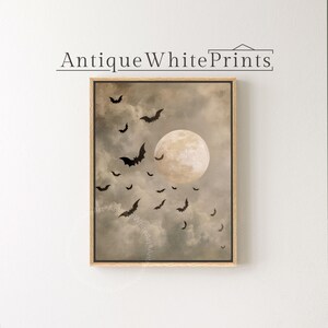 May include: A framed print featuring a full moon and silhouetted bats against a cloudy, sepia-toned sky. The artwork has a vintage aesthetic, with the text "Antique White Prints" at the top. The image evokes a Halloween or gothic theme.