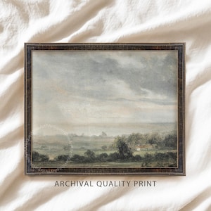 May include: Framed landscape print featuring a serene countryside scene under a cloudy sky. The artwork showcases a field, trees, and a distant building, all rendered in muted tones. The frame is dark brown. Text at the bottom reads "ARCHIVAL QUALITY PRINT".