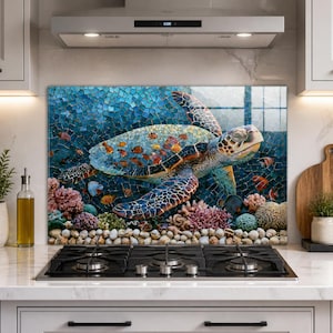 May include: A rectangular kitchen splashback panel featuring a mosaic-style print of a sea turtle swimming among colourful coral reefs and small tropical fish. The artwork displays vibrant shades of blue, orange, and pink against a textured background.