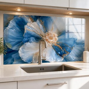 May include: A rectangular kitchen backsplash panel featuring a large, abstract floral design in shades of deep blue, light blue, and white, accented with metallic gold veins and a textured, crystalline center, installed behind a stainless steel sink.