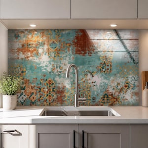 May include: A kitchen backsplash panel featuring a distressed, multi-colored pattern in shades of teal, rust orange, and cream. The design incorporates faded geometric and floral motifs across the surface, positioned behind a stainless steel faucet.
