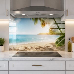 May include: A rectangular kitchen splashback panel featuring a high-resolution print of a tropical beach scene with golden sand, turquoise ocean water, and green palm fronds hanging in the upper right corner under a bright sun.