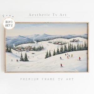 Puede incluir: Una pintura que representa una escena de montaña nevada con un pueblo en la distancia y personas esquiando por una ladera. La pintura está enmarcada en un marco de madera claro. El texto "Aesthetic Tv Art" está en la parte superior de la imagen y "Premium Frame Tv Art" está en la parte inferior.